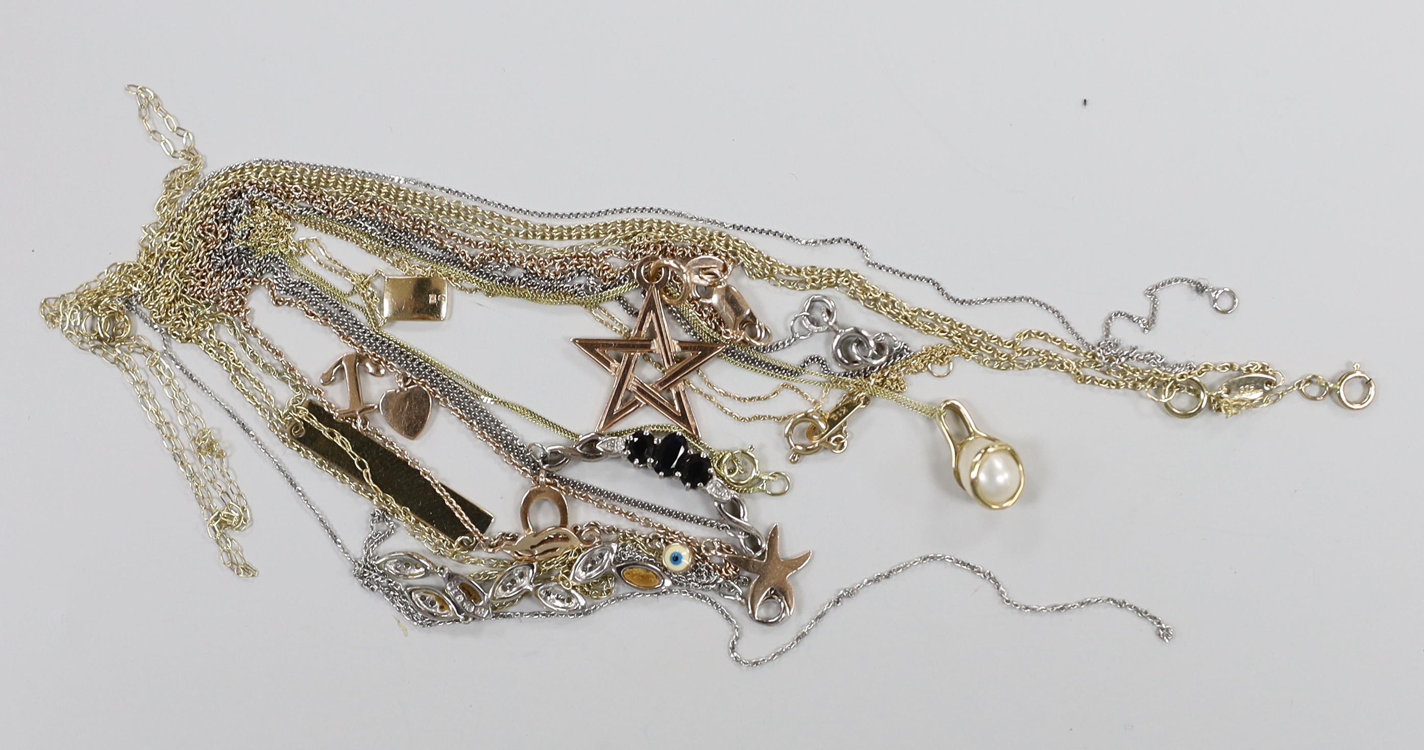 Three assorted modern 375 pendant necklaces, including a 9ct white gold, sapphire and diamond chip, 36cm, one 10k pendant necklace, sundry damaged 375 necklaces, gross 10 grams and a 925 chain